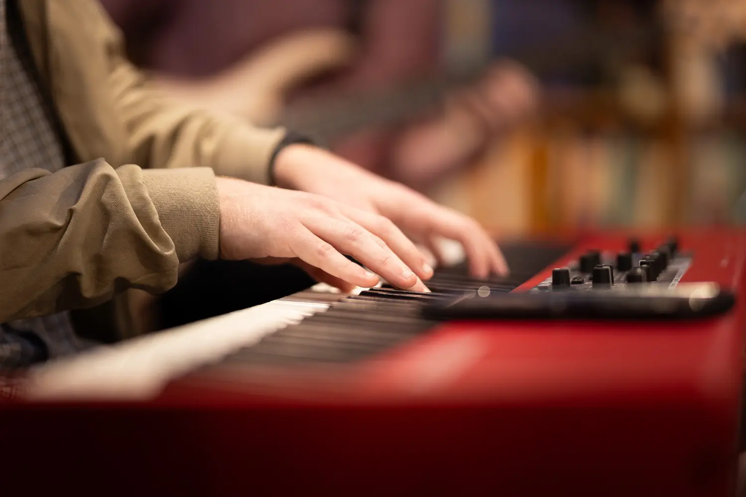 Reuben's hands playing a keyboard during a performance