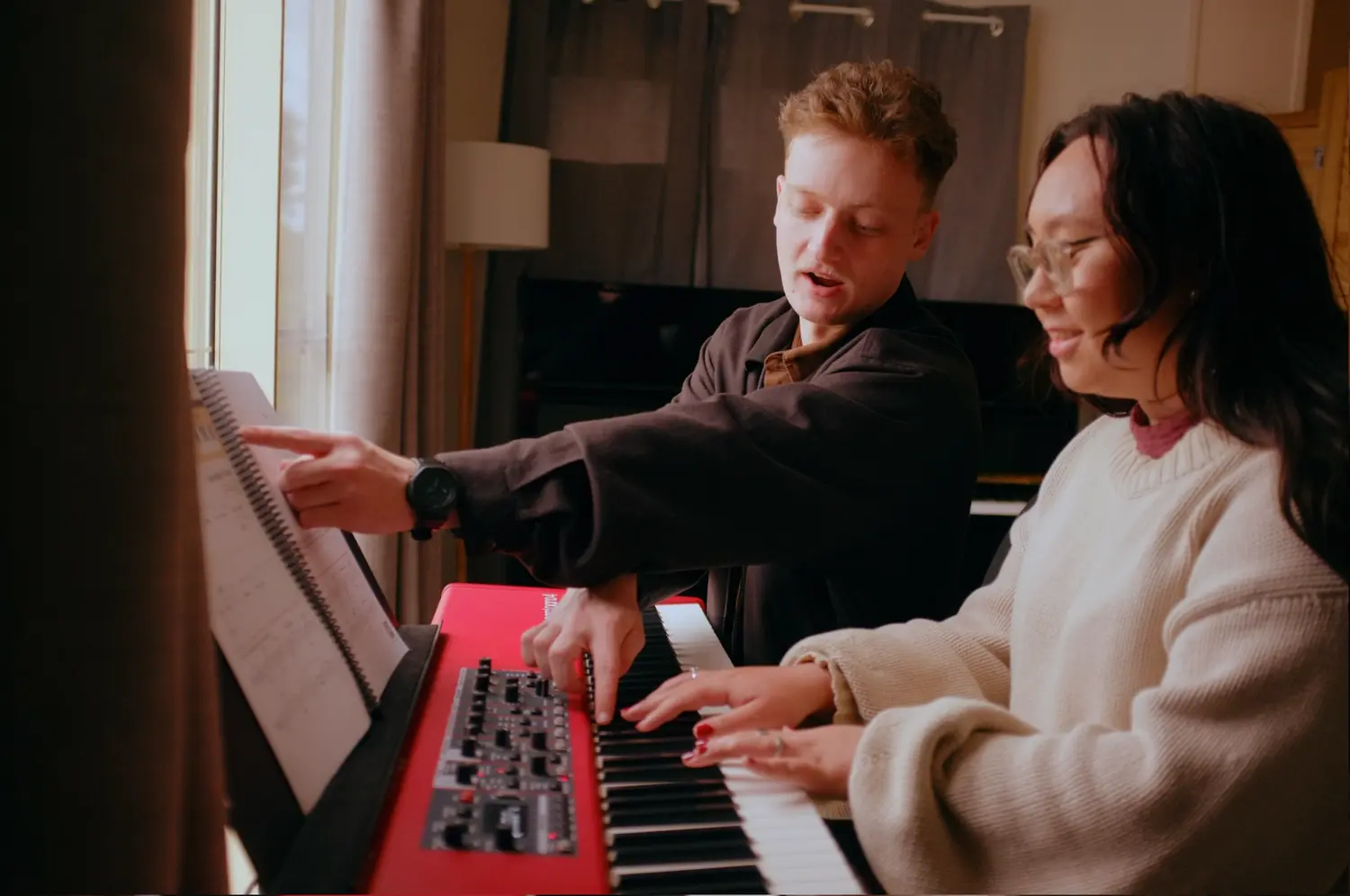 Reuben working through sheet music with a piano student